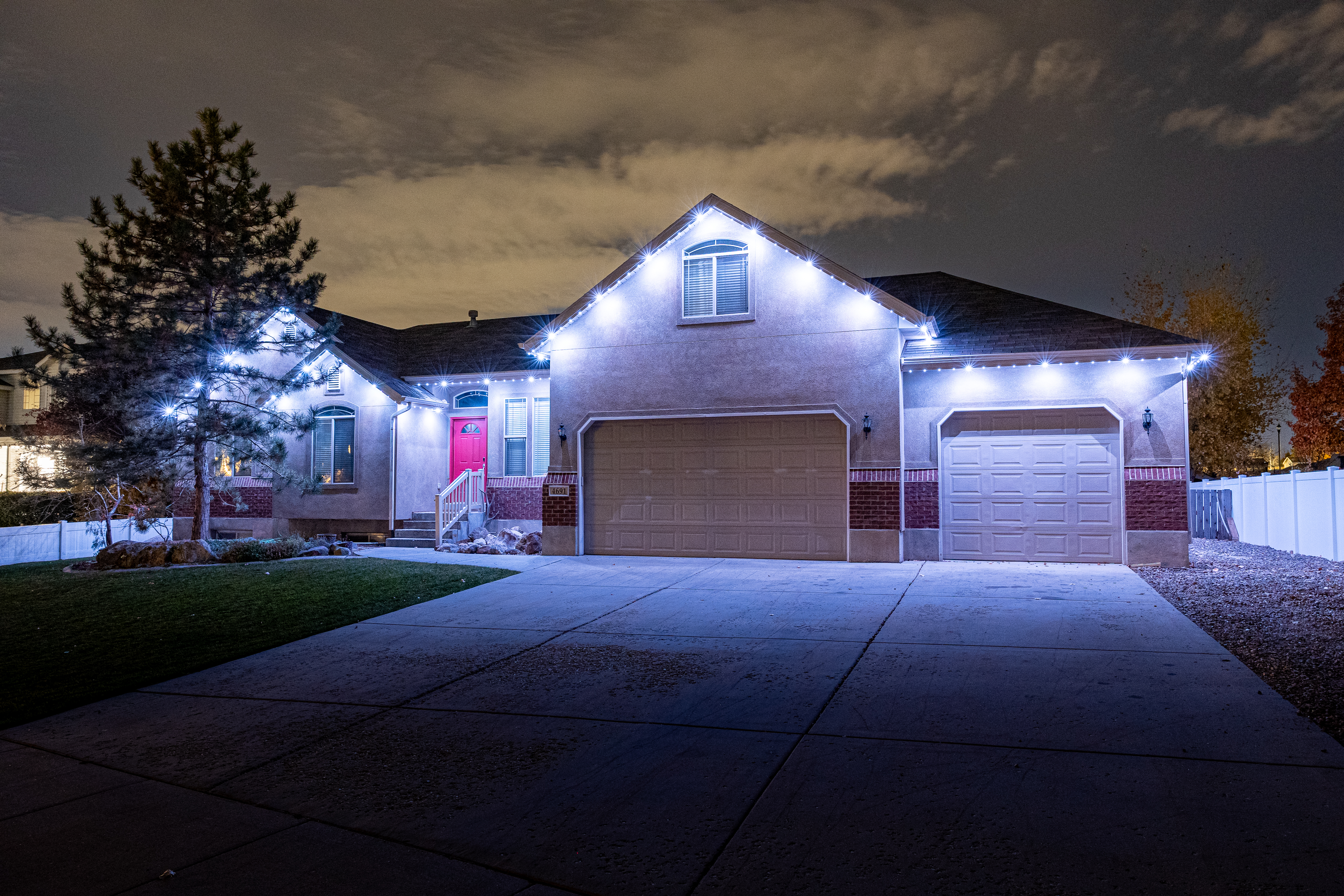Two-story home lit at dusk